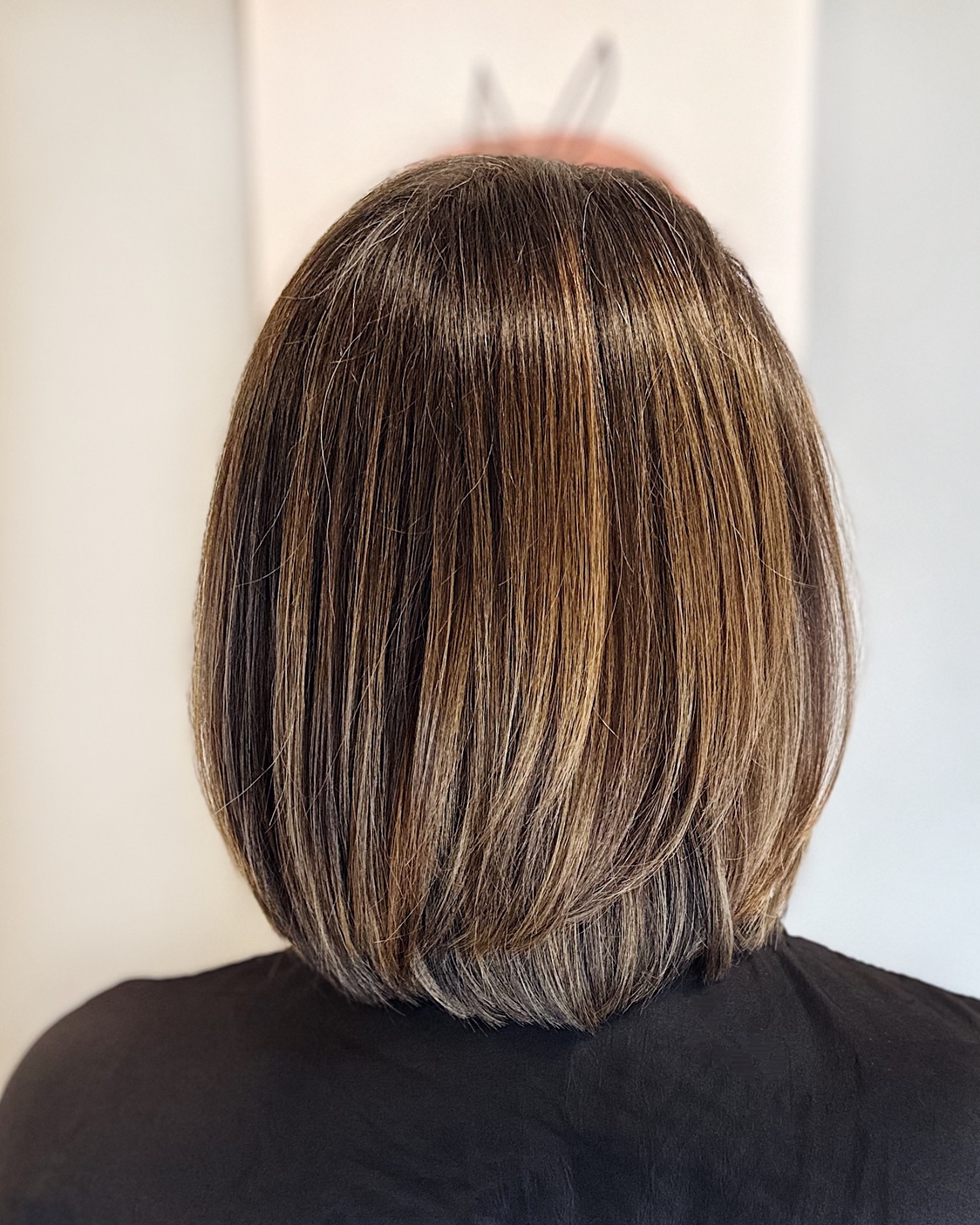 Dimensional brunette bob with subtle highlights and glossy finish by Jenna Schermerhorn